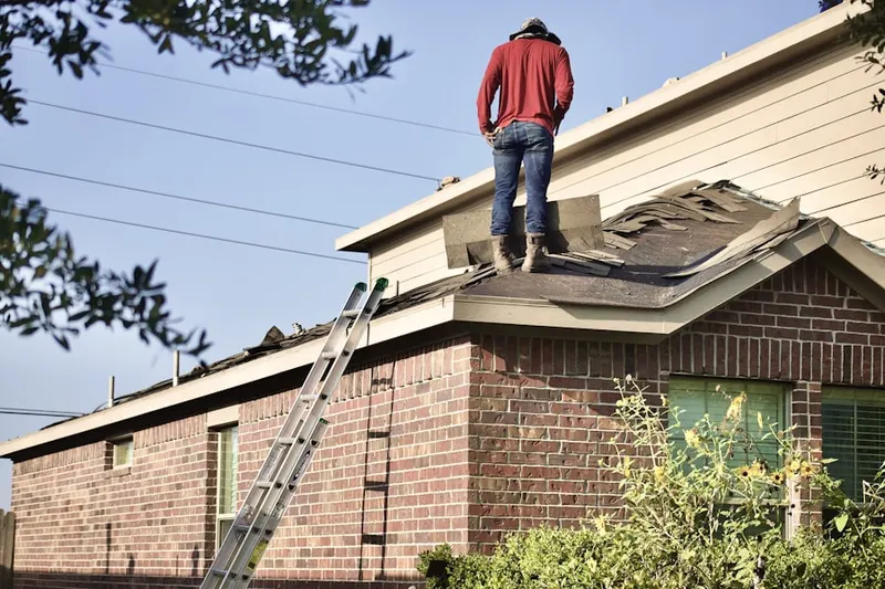 Professional roofer working on a residential roof in Muddy Creek